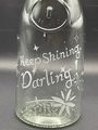 Close up view of front design with hand etched lettering on glass pitcher. Reads "Keep shining, Darling." Stars of various shapes and sizes surround the lettering.